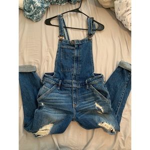 Distressed denim overalls